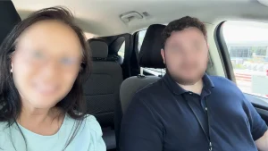 Blurred corporate interview video still showing two people in a car, used in training video creation for nonprofits or internal comms