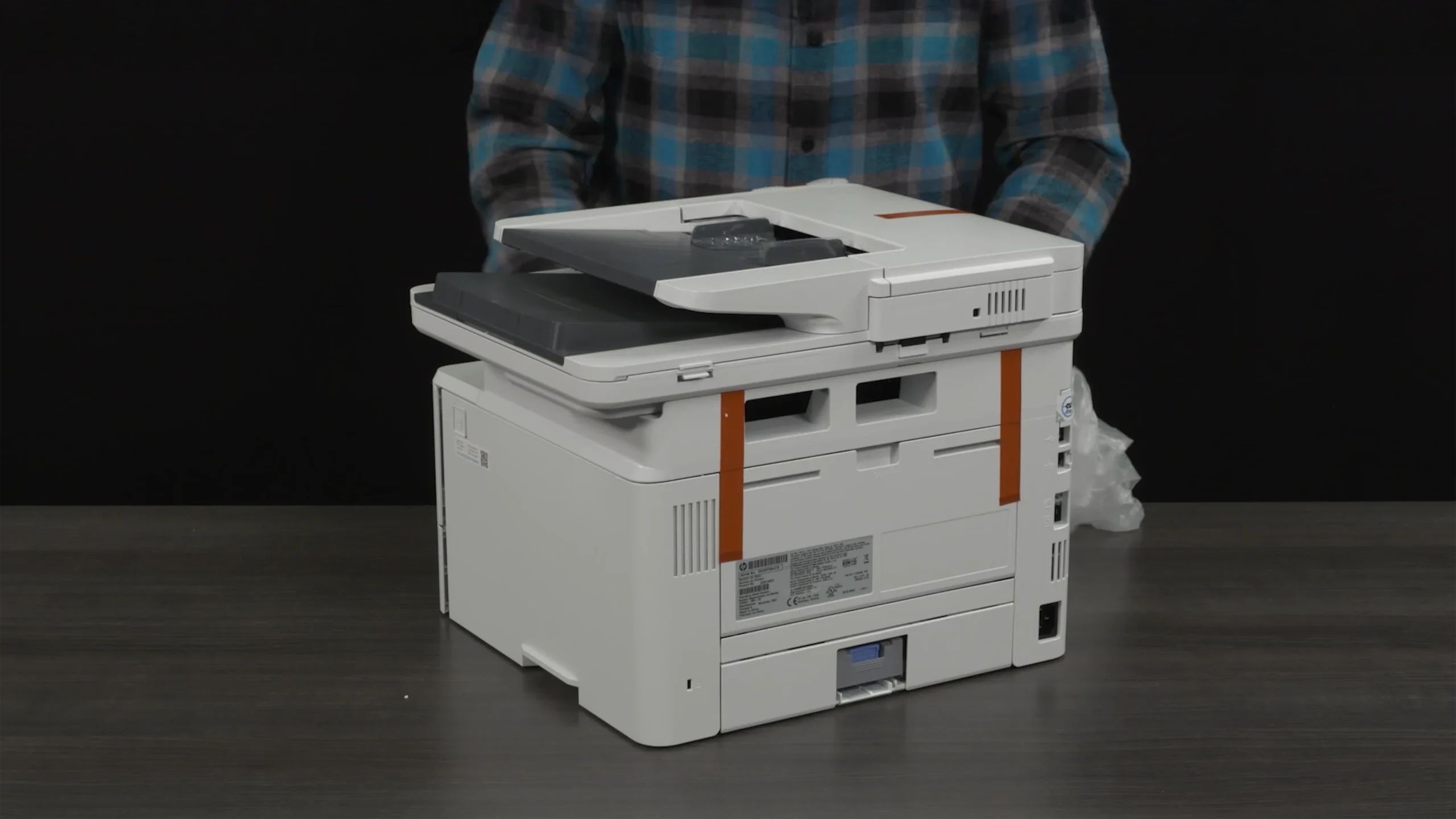 Unboxing the HP LaserJet Pro printer during the setup tutorial video production