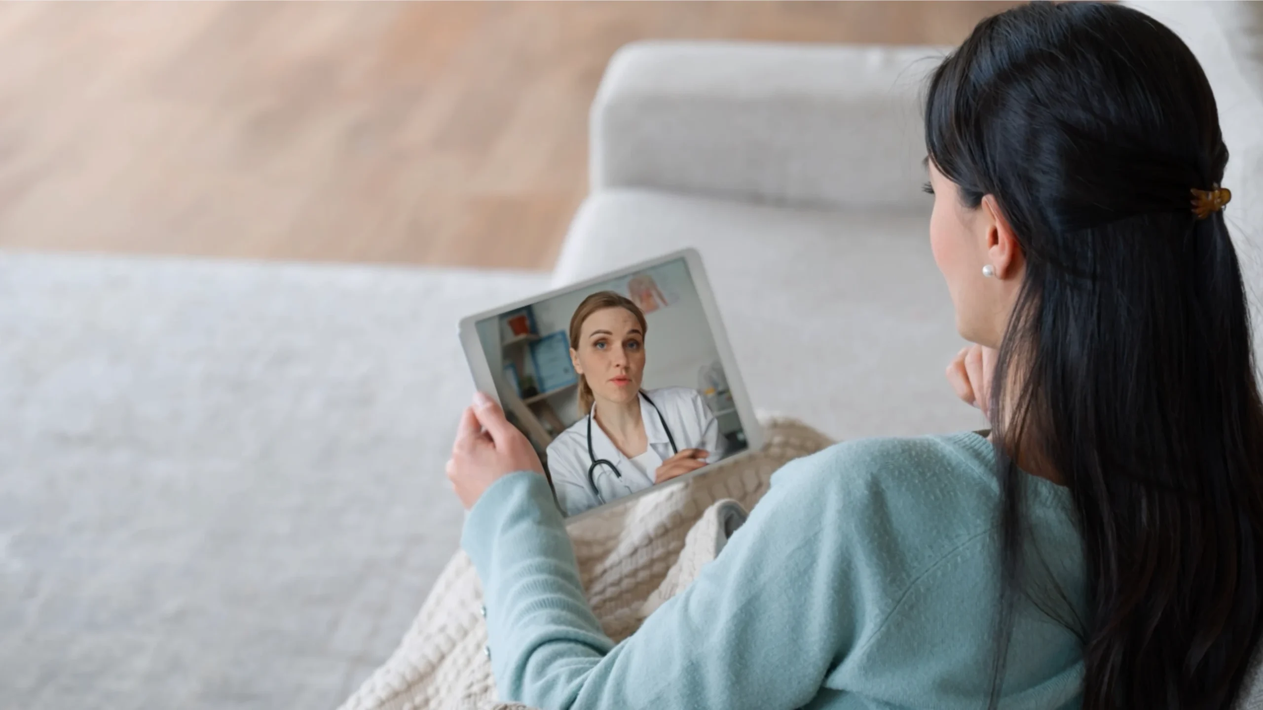 Patient using a tablet to video chat with a doctor, representing virtual care in healthcare explainer video.